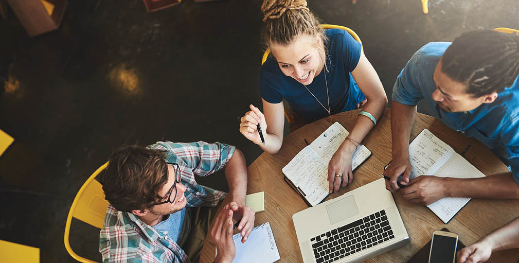High angle shot of a group of students studying in a coffee shop